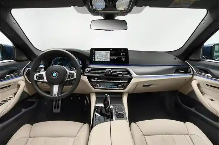 Luxurious BMW car interior featuring beige leather seats, a digital dashboard, steering wheel with controls, and a sleek design.
