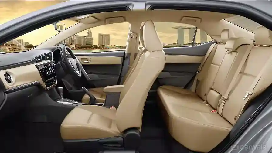 Spacious car interior with beige seats, featuring a modern dashboard and a city skyline visible through the windows.