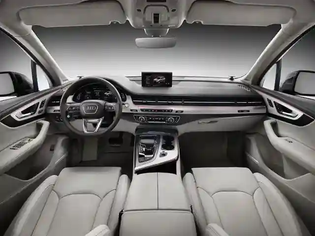 Luxury car interior featuring leather seats, a sleek dashboard, and a central infotainment display. Modern and minimalistic design.
