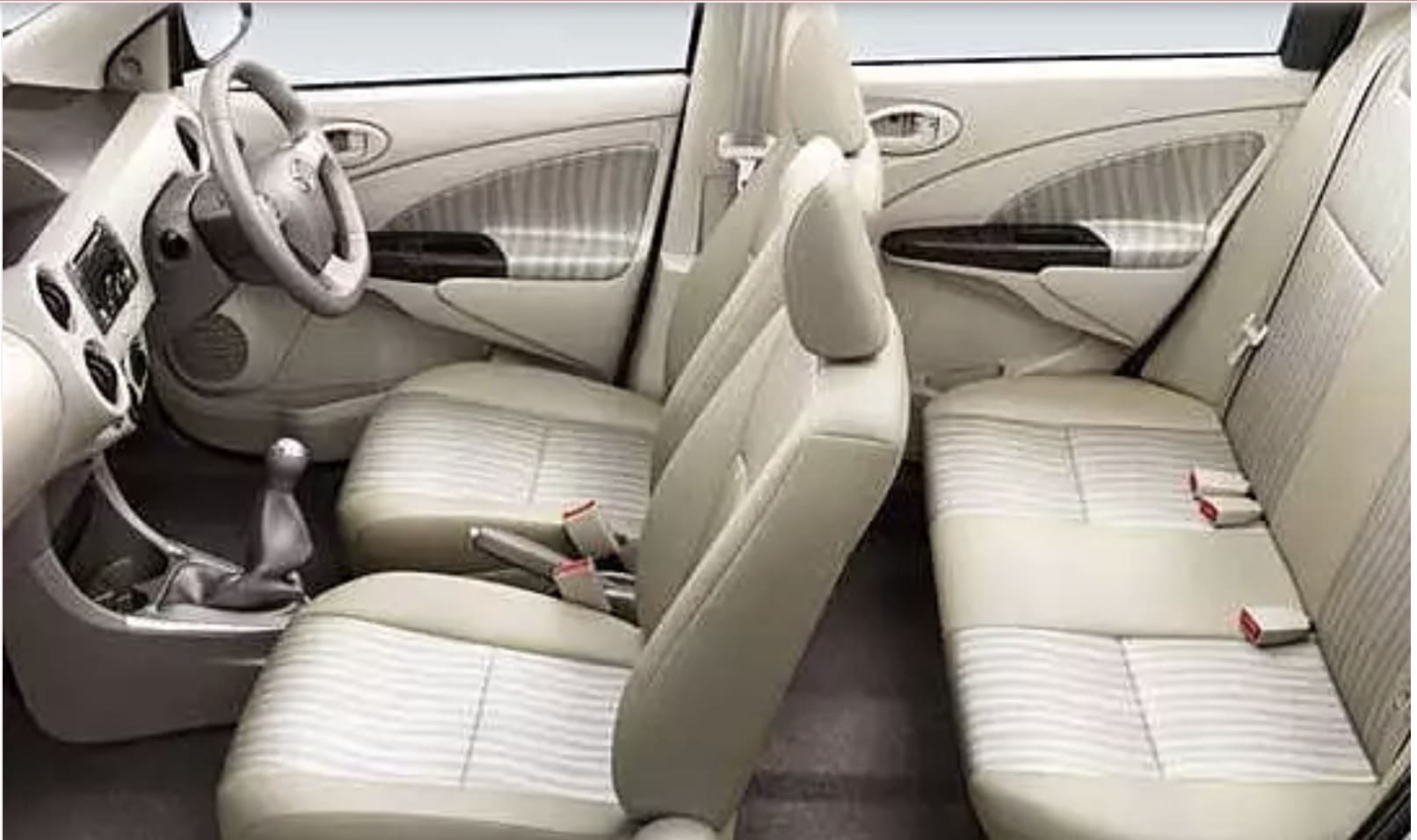 Interior of a car featuring beige leather seats, a steering wheel, and a gear shift, with a minimalist design.